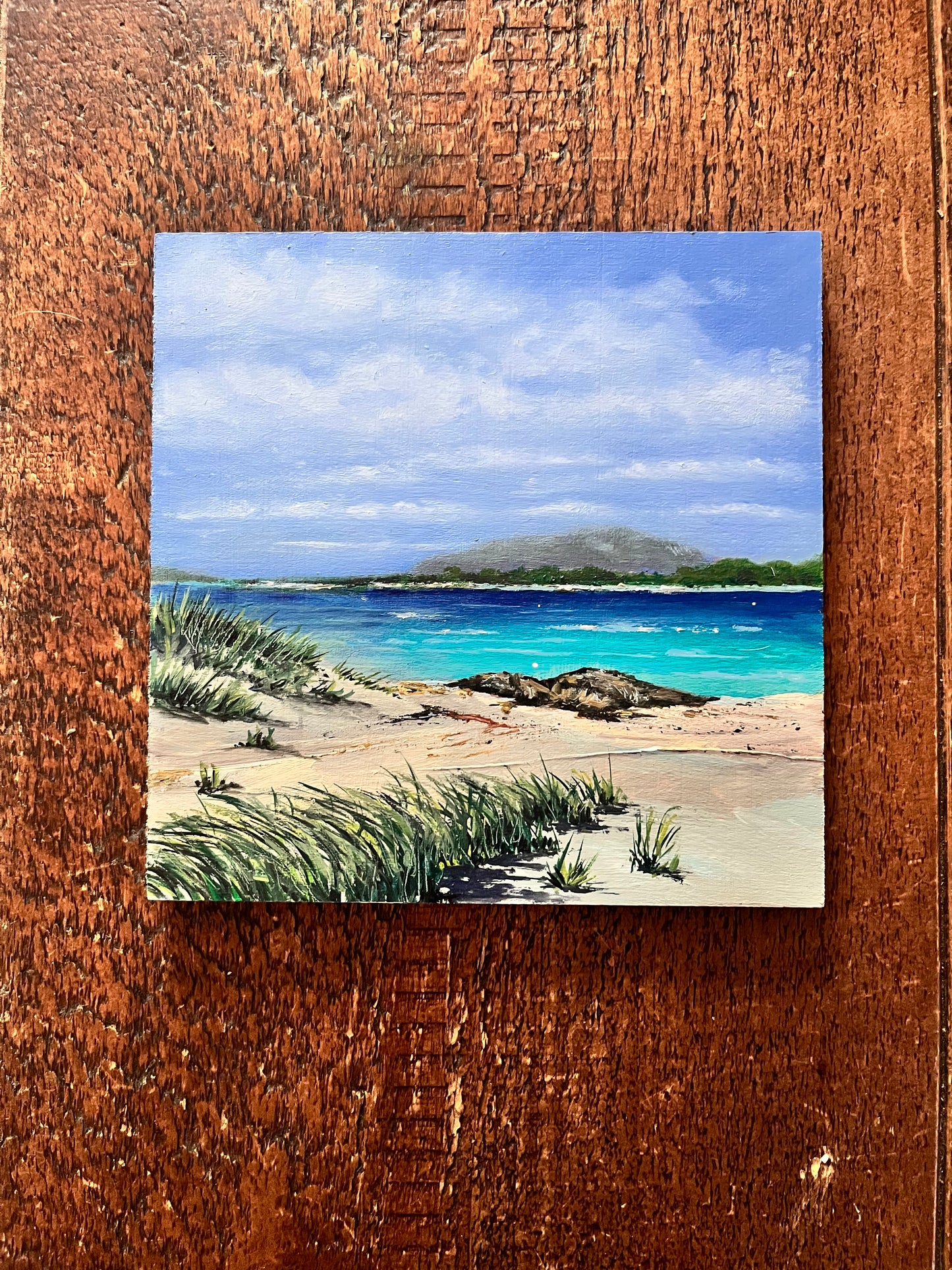 Beach scene in oil on a birch panel