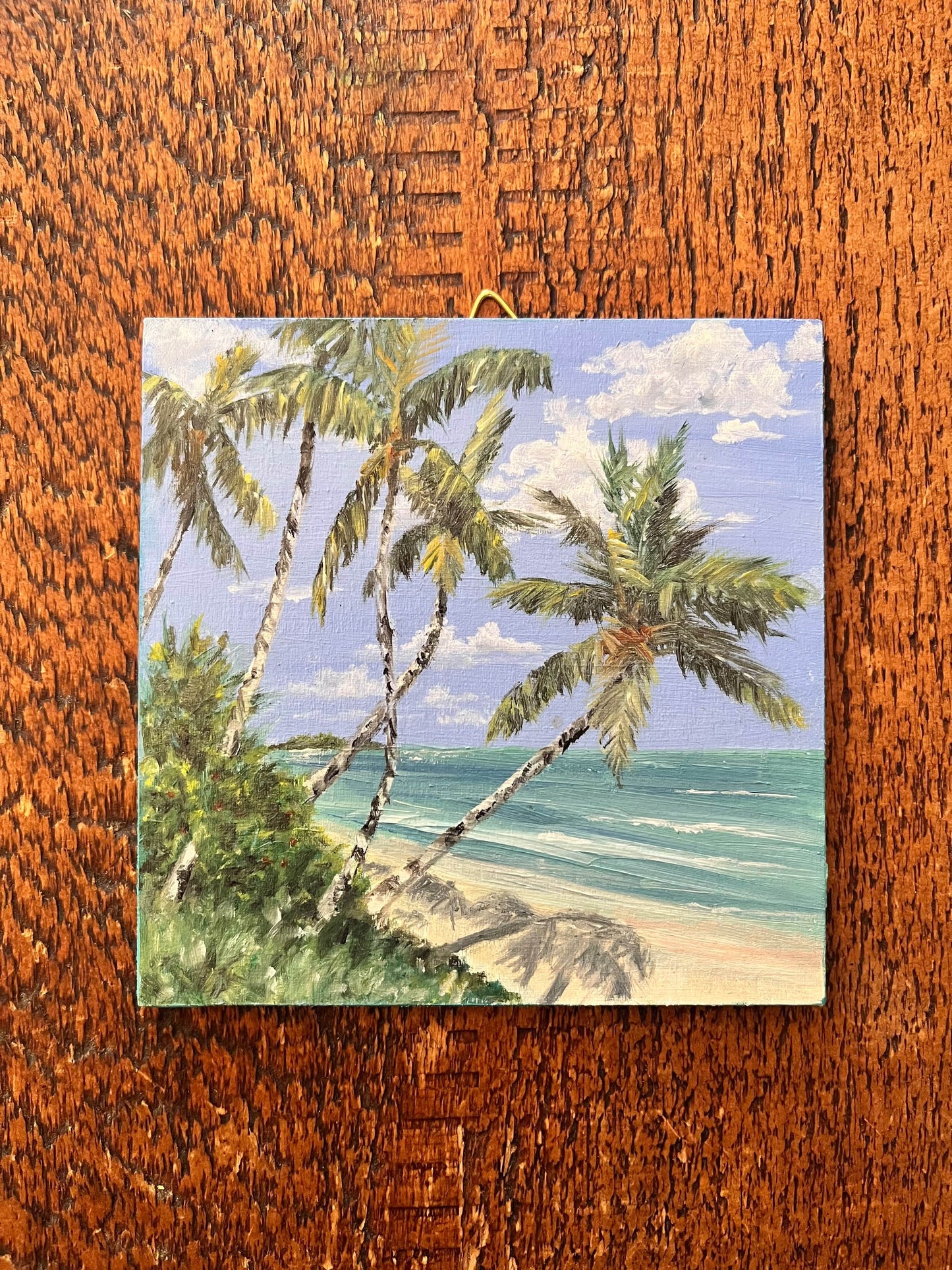Beach scene in oil on a birch panel